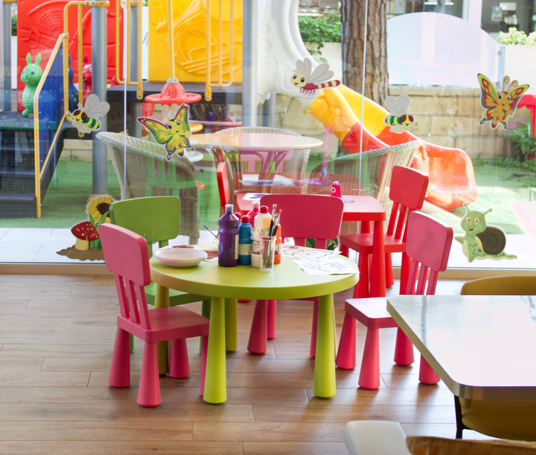 Colorful play area with tables and chairs for children.