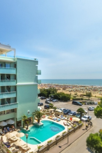 Hotel with pool near a crowded beach.