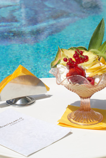 Fresh fruit on a poolside table, relaxing atmosphere.