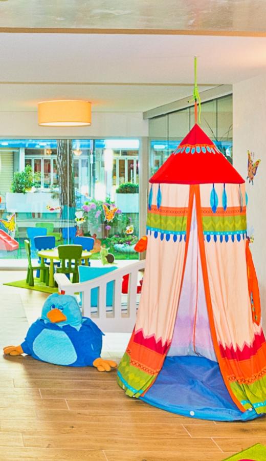 Colorful play area with tent and plush toy.